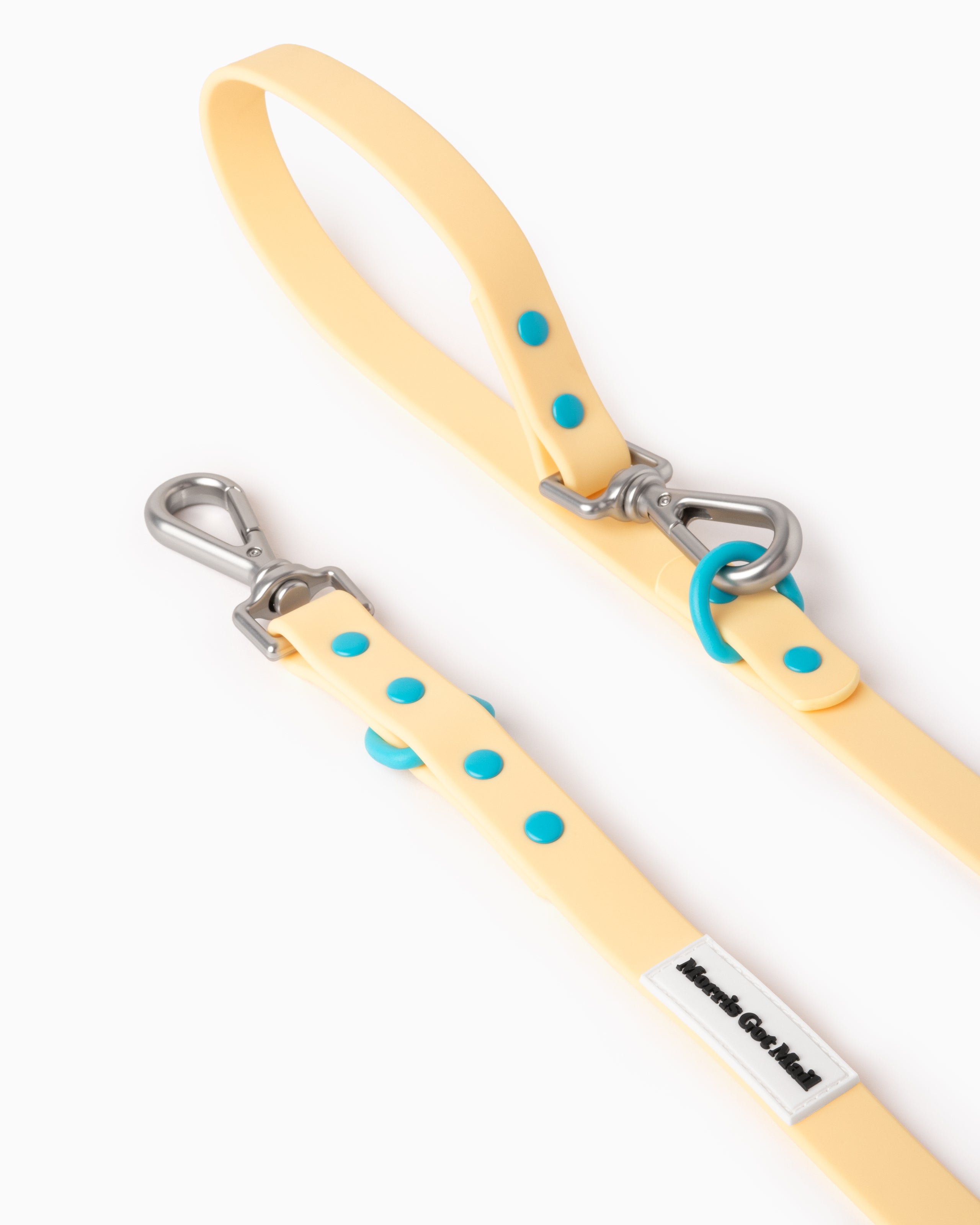 Buttery yellow waterproof & odor resistant dog leash with a two tone colorblock design, two length options, a handle, carbon coated steel hardware, & zinc alloy attachment hooks.